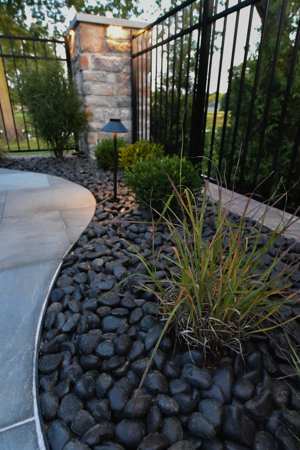 Stone piers and low wall framing a poolside landscape